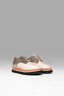 A pair of beige and metallic textured sneakers with a chunky layered sole.