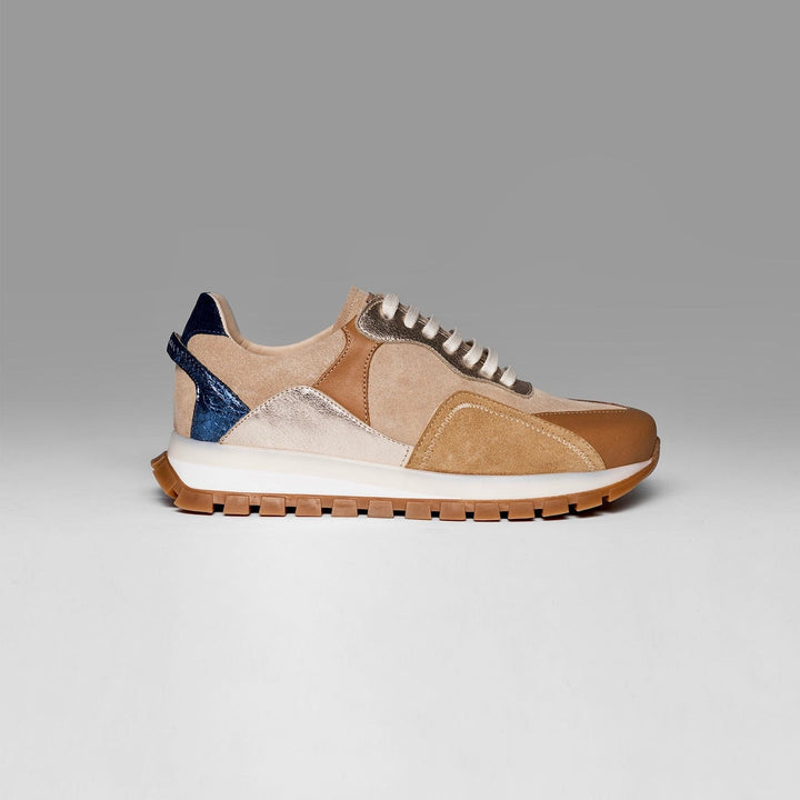 Multicolored sneaker with a mix of beige, brown, and blue on a gray background